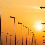 Street lamp poles and beautiful sunset sky.