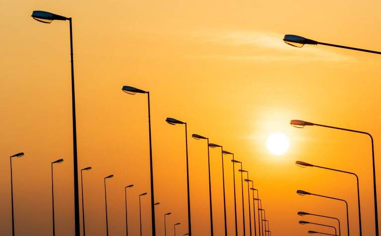 Street lamp poles and beautiful sunset sky.