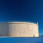 Giant Municipal City Water Tank on a Sunny, Clear Day with Snow