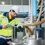 woman inspection engineer working in term of water quality checking control, food factory industry production plant, business work with equipment line machine technology