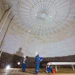 Male worker inspection visual record draft tank oil bottom steel weld  with spot lighting internal confined specs