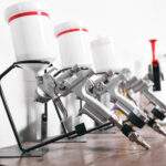 spray gun on wood table. in auto service. used for industrial painting and coating.