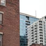Residential skyscrapers in the dowtown of Montreal, seen from a nearby street of the main city of Quebec, a symbol of the Canadian economy surrounded by older red brick houses

Picture of residential towers during a cold and cloudy afternoon seen from a nearby  street in Montreal CBD, Quebec, Canada, with older red brick buildings around. Montreal is the second most important city in Canada, and a major economy and investments hub in North America