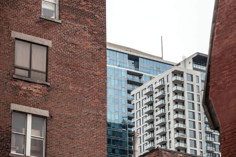 Residential skyscrapers in the dowtown of Montreal, seen from a nearby street of the main city of Quebec, a symbol of the Canadian economy surrounded by older red brick houses

Picture of residential towers during a cold and cloudy afternoon seen from a nearby  street in Montreal CBD, Quebec, Canada, with older red brick buildings around. Montreal is the second most important city in Canada, and a major economy and investments hub in North America