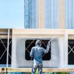 Airless Spray Painting, Worker painting on steel wall surface by airless spray gun for protection rust and corrosion.